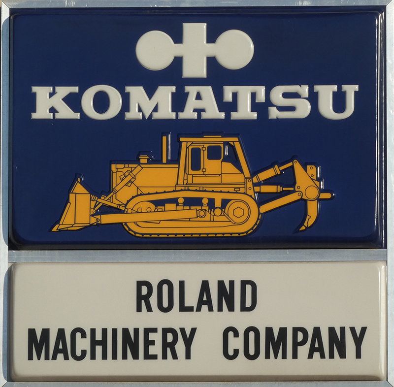 excavator graphic with text reading roland machinery company below